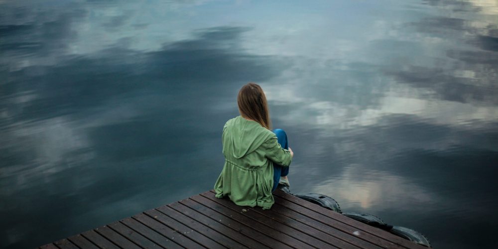 woman-sitting-on-wooden-planks-2865901